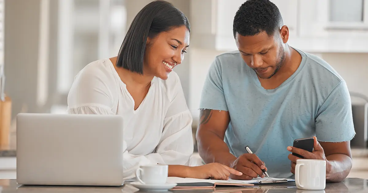 Shot of a couple going over paperwork together at home