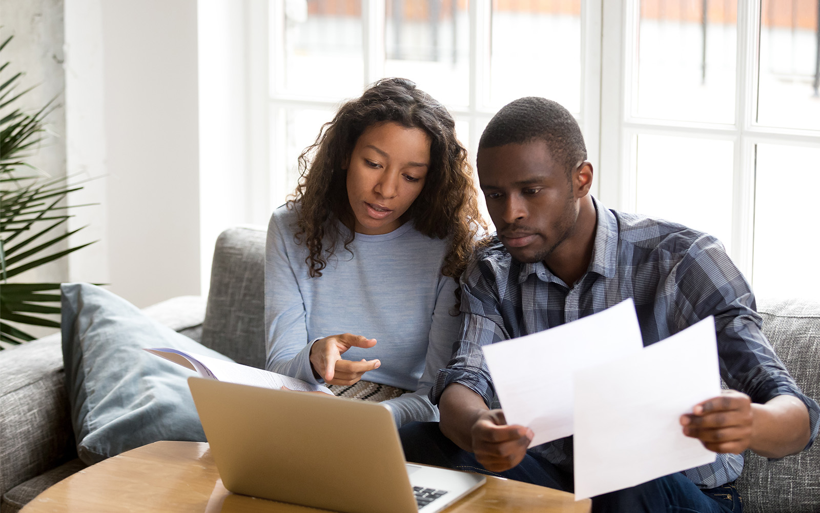 man and woman looking at laptop