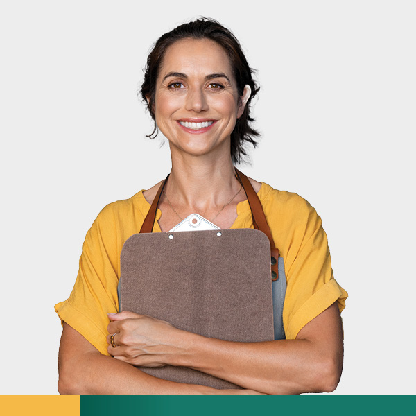 Young woman smiling while holding a clipboard