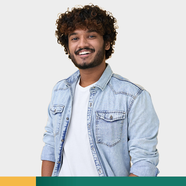 Young man in denim shirt smiling